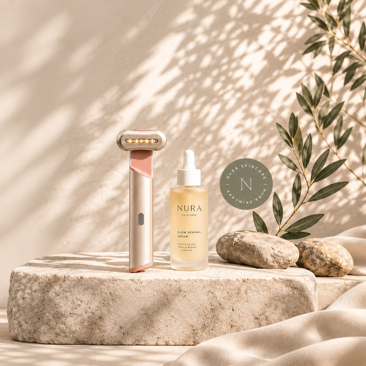 NURA light therapy wand and Glow Renewal Serum on a stone pedestal
